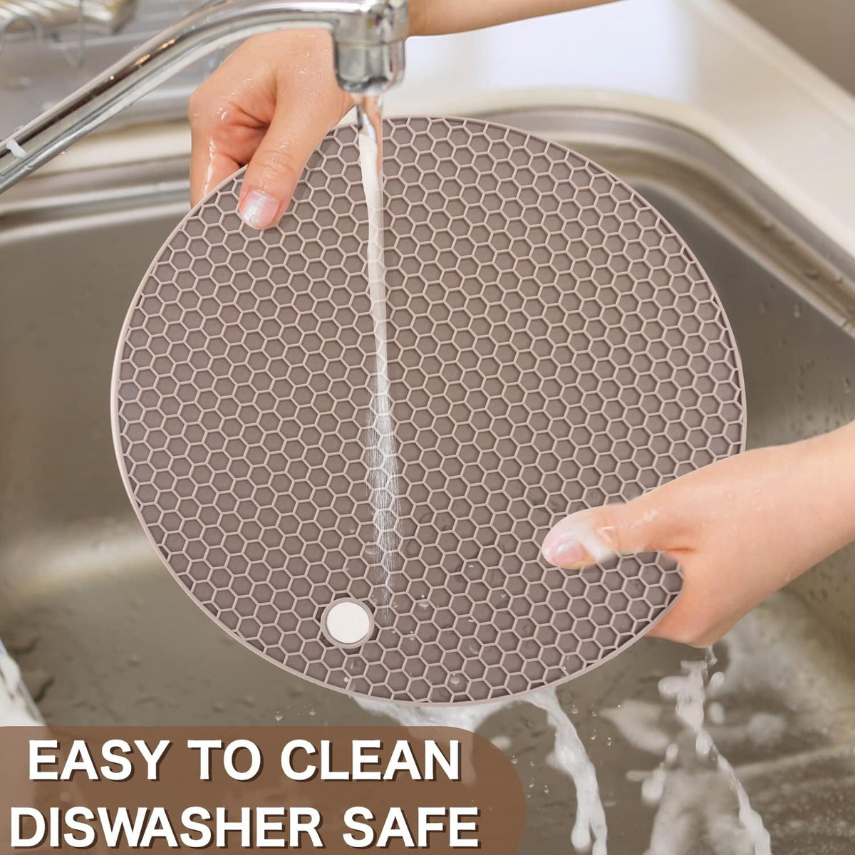 Almond silicone trivet being rinsed in a sink