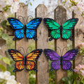 Set of four colorful metal butterflies on a garden fence; fence not included