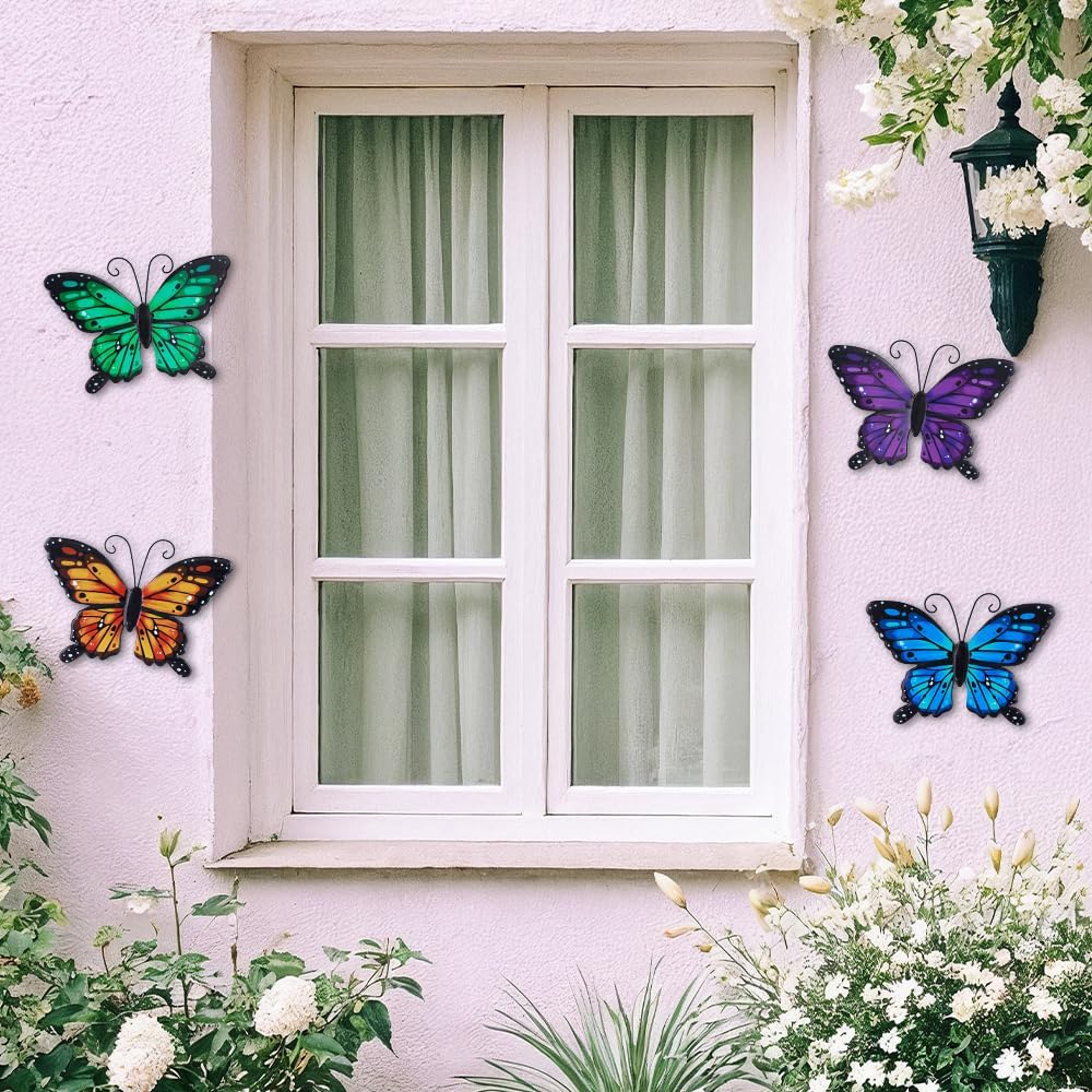Blue, green, orange and purple butterfly wall decorations beside a window