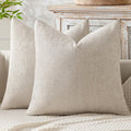 Two beige chenille pillow covers styled with inserts, inserts not included