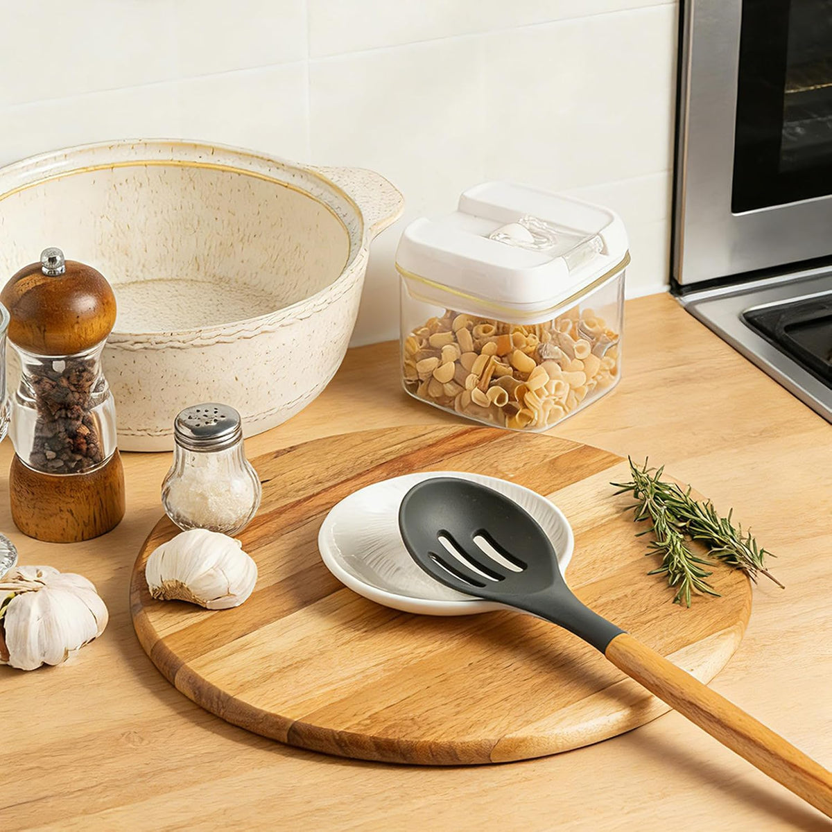 White spiral glazed ceramic spoon rest on a kitchen counter; utensil and accessories not included